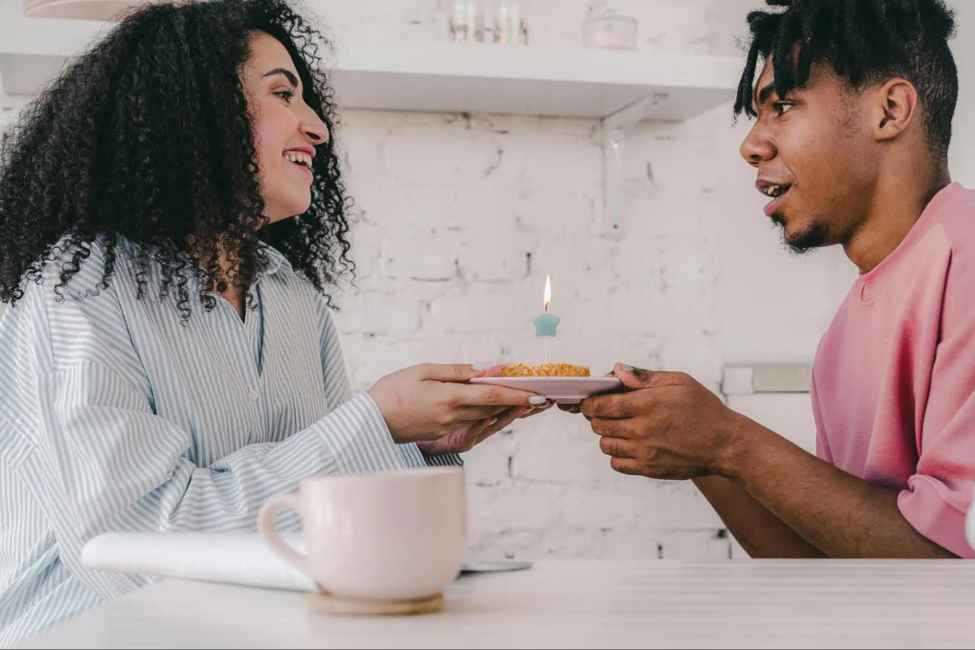 A man giving a cupcake to woman 