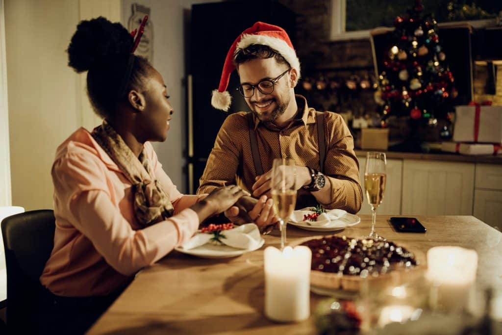 A couple having wine while having dinner.