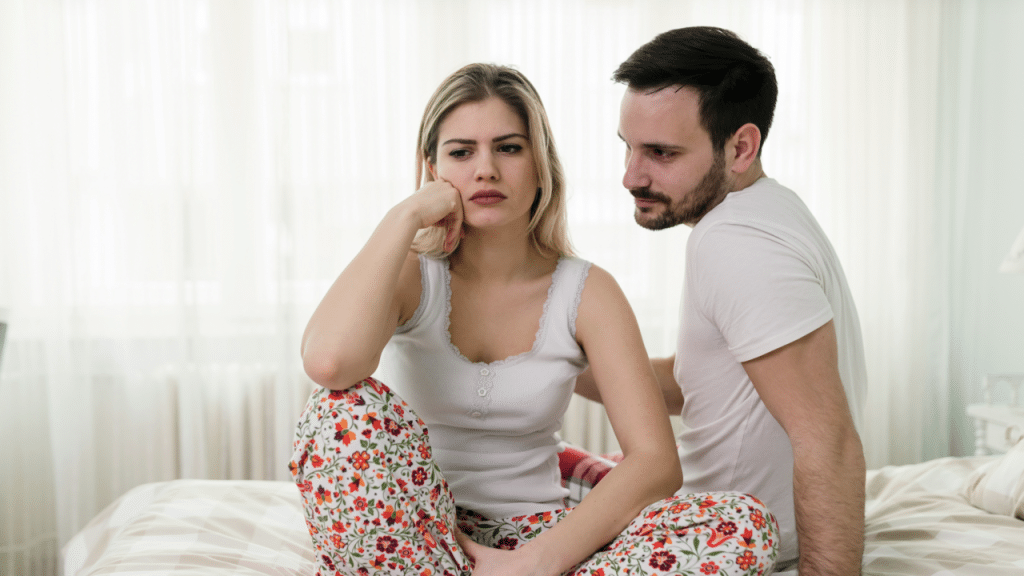 A couple looking sad in the bedroom