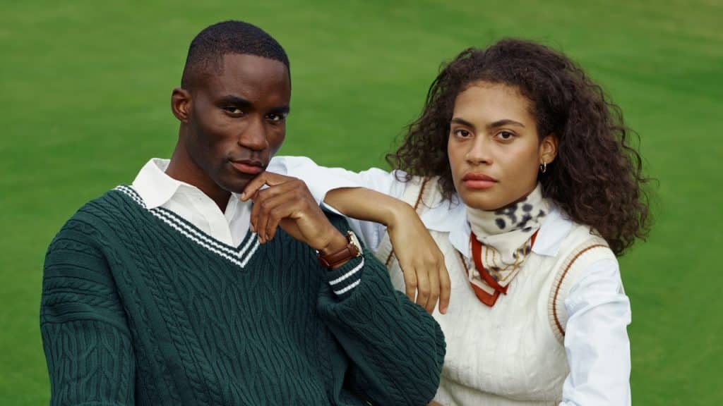 A man and a woman sitting on a bench.