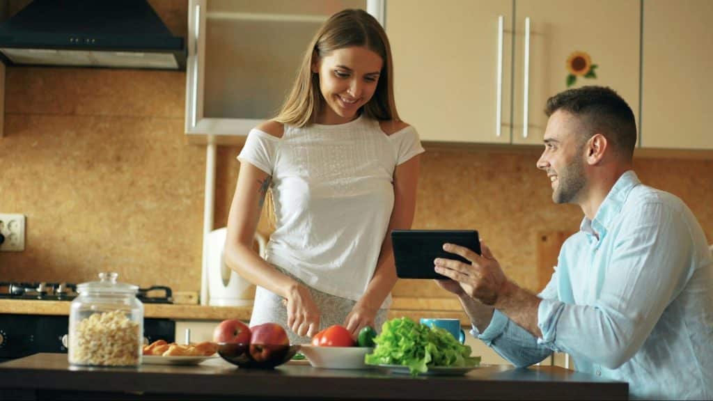 A woman preparing a food for a man