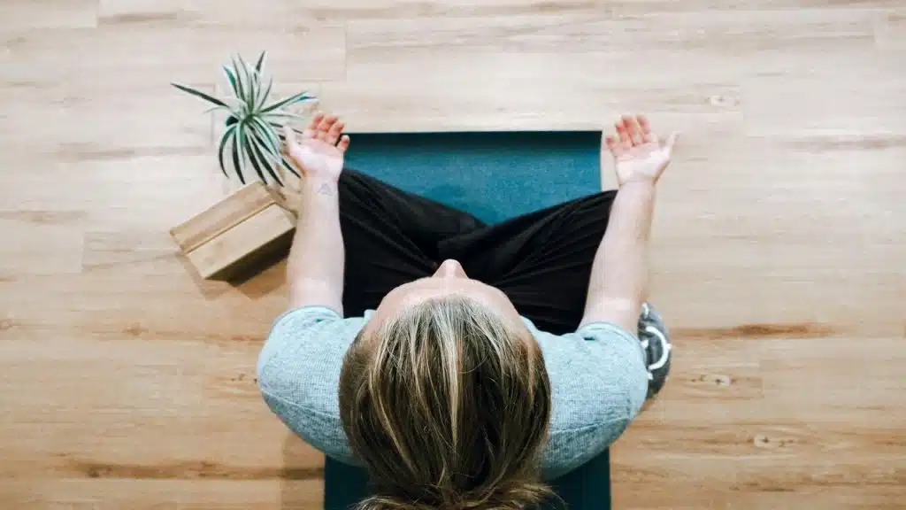 A person meditating at home