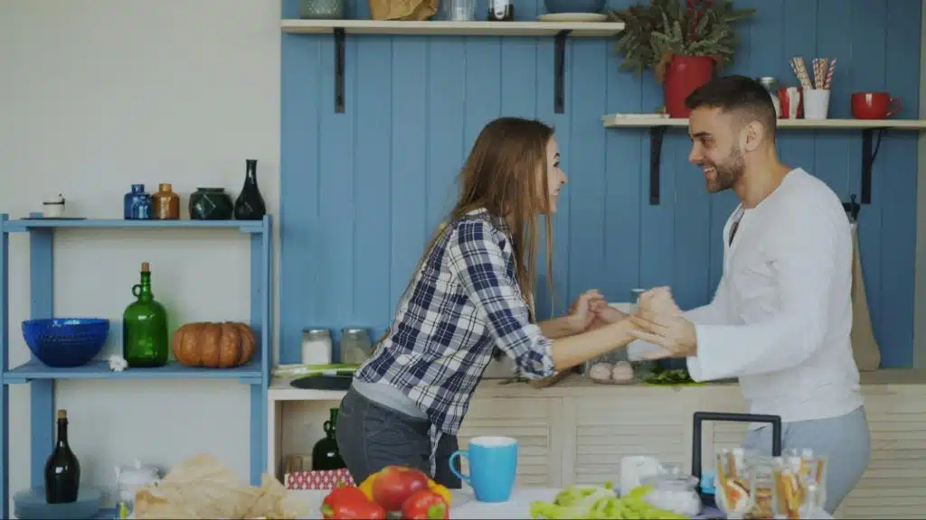 A man and woman at the kitchen