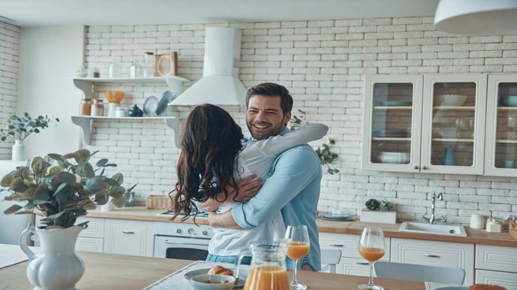 A couple hugging in the kitchen