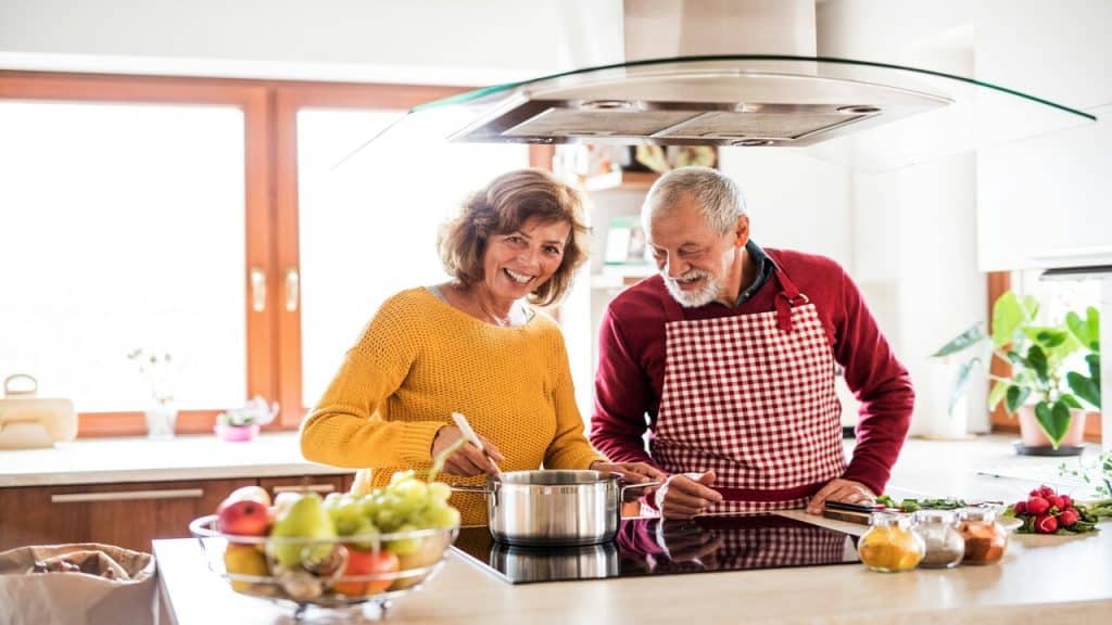 An older couple cooking together