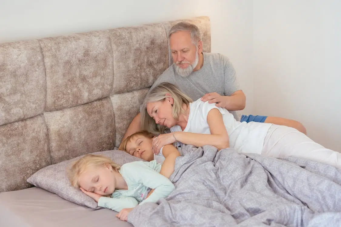 A man and woman putting the kids to sleep