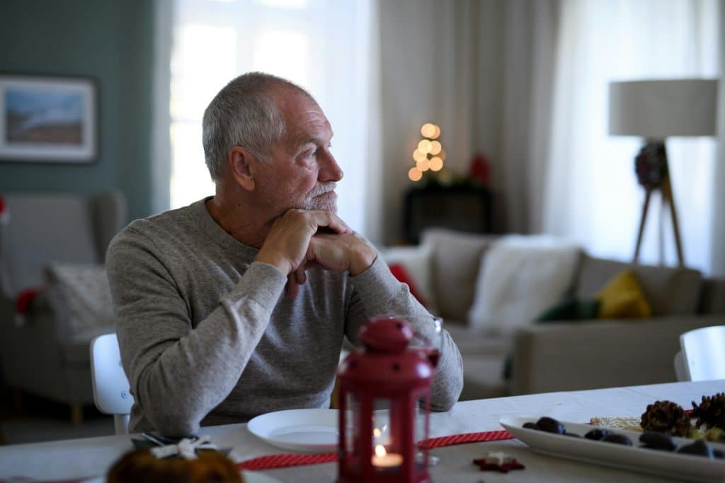 A man sitting at a table indoors.