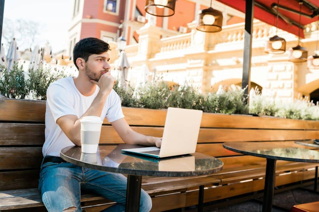 A man sitting alone in a coffee shop.