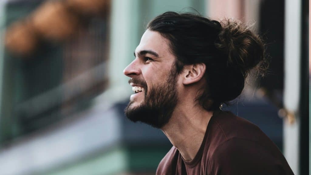 A side view of a man smiling.