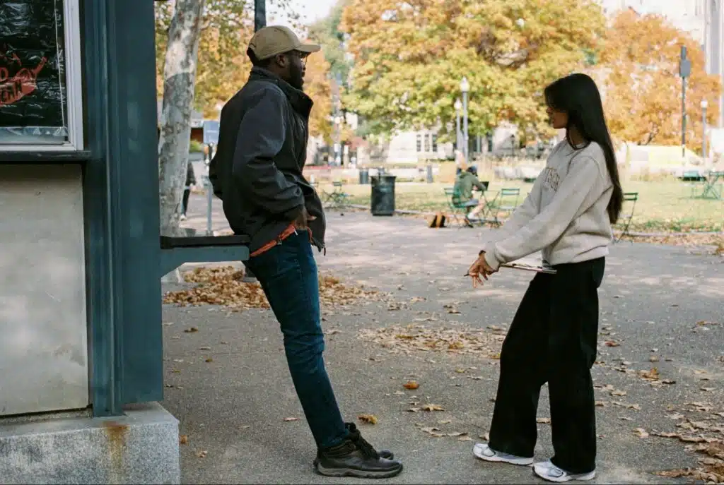 A man and woman talking outside