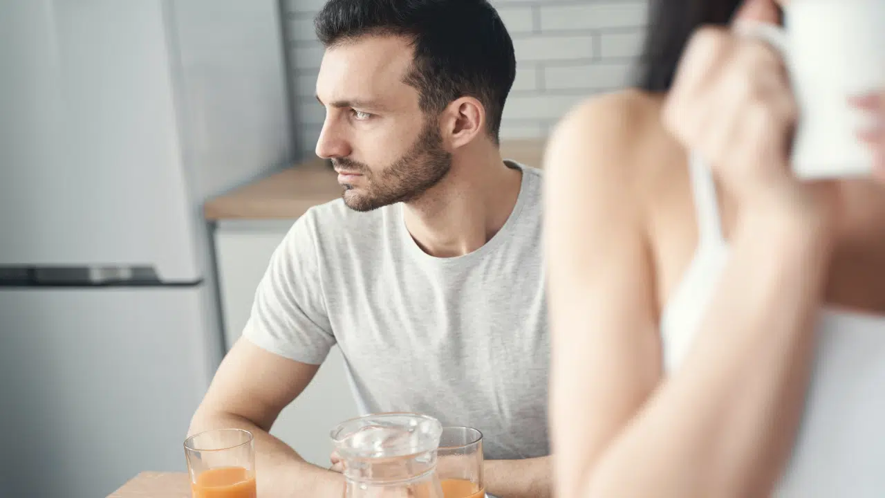 A man looking ambivalent during breakfast