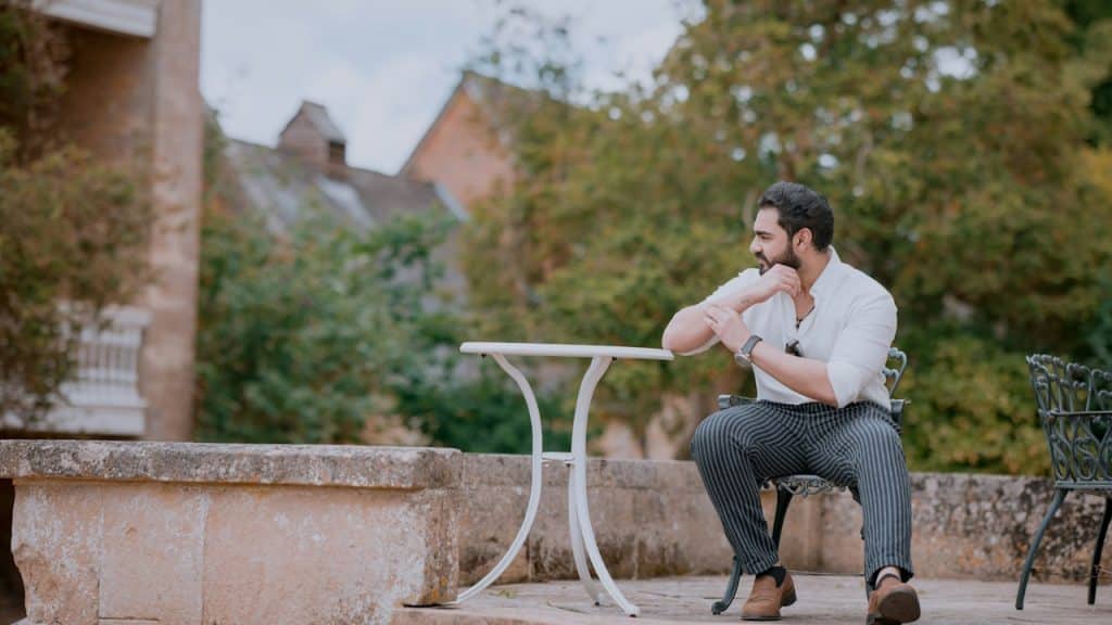 A man sits alone contemplating outside.