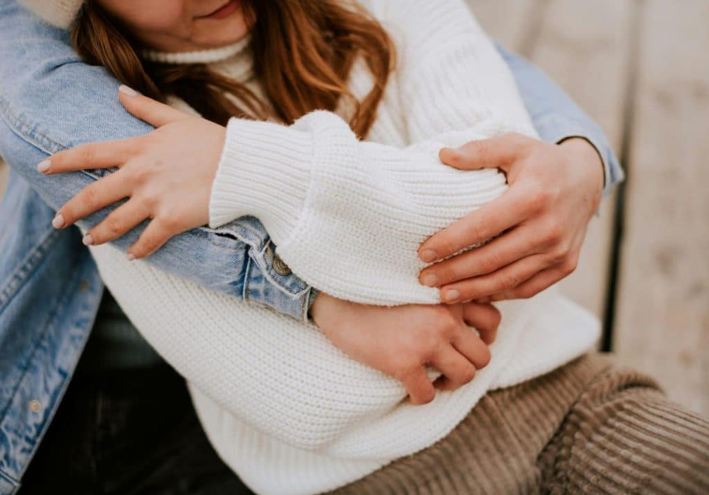 A man hugging a woman