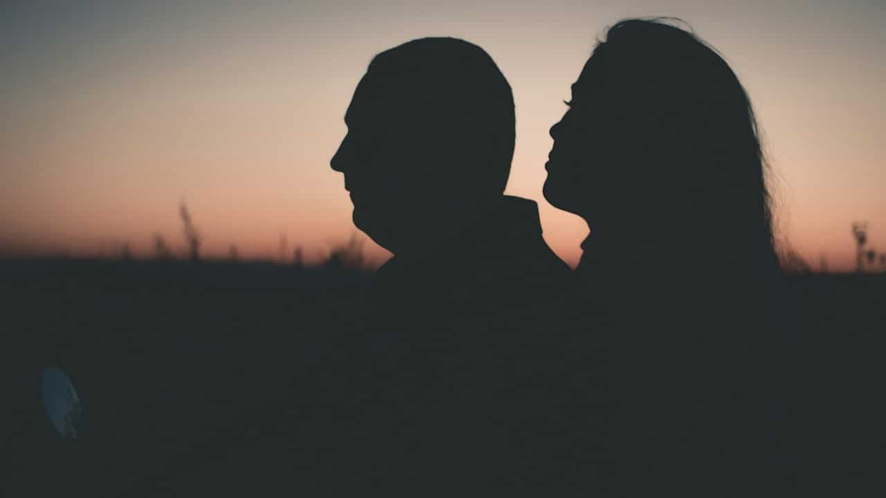 A silhouette photograph of a man and woman.