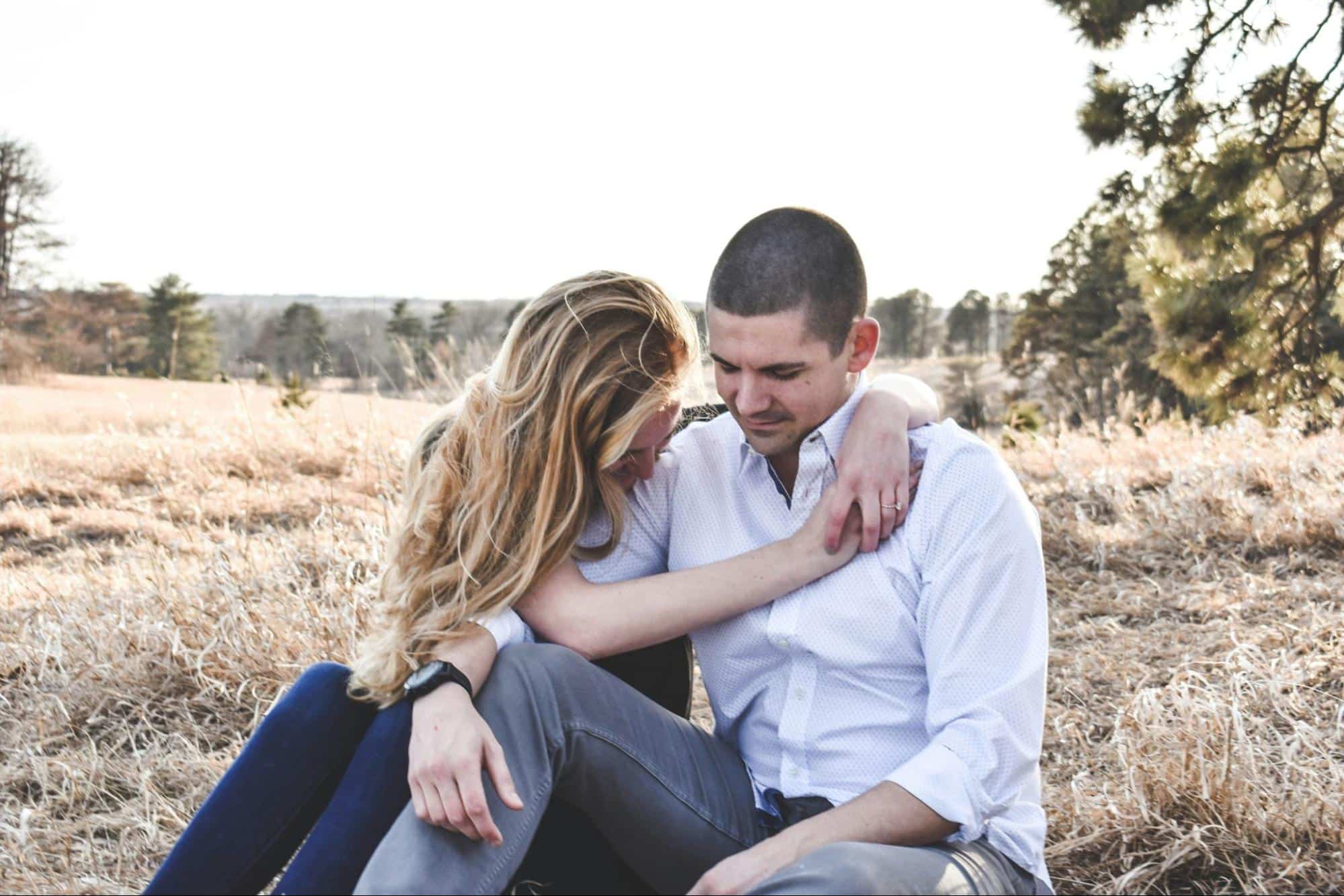 A woman hugging a man 