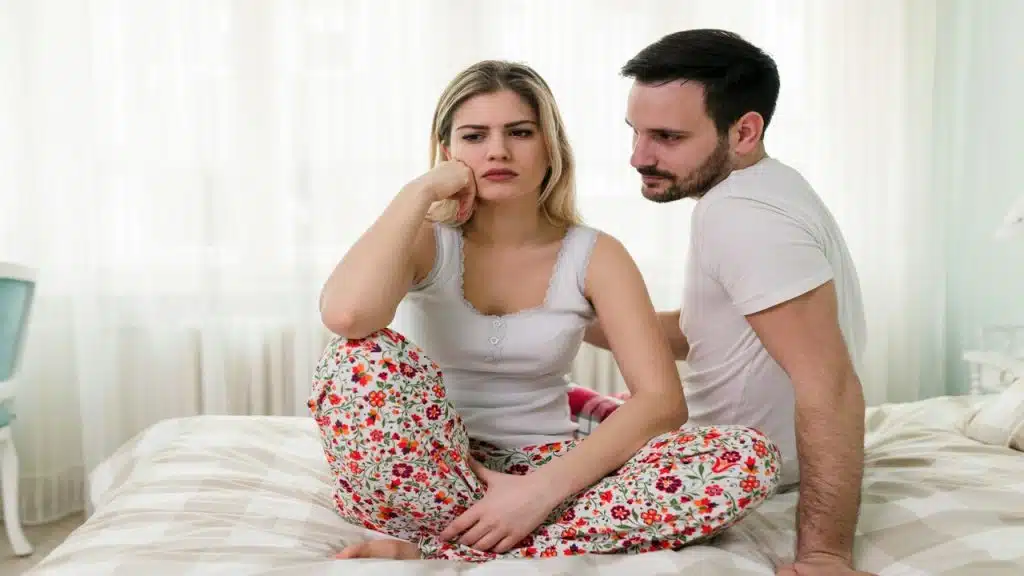 A couple fighting in bed