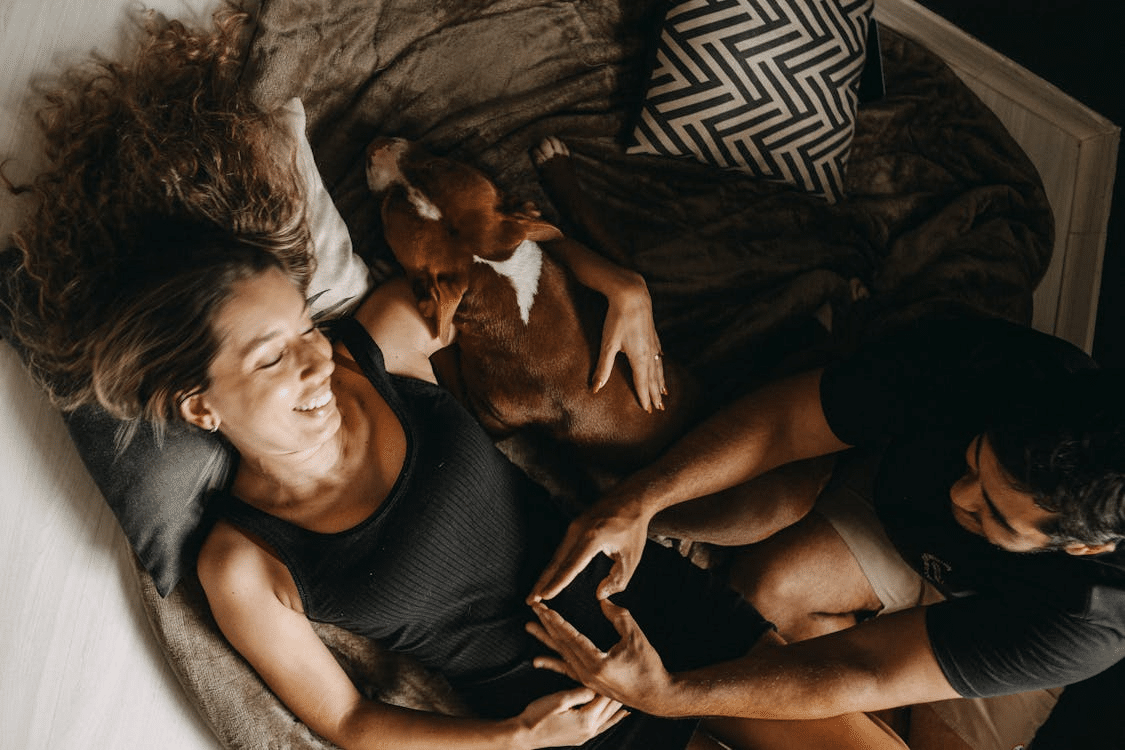 A man and a woman with a dog