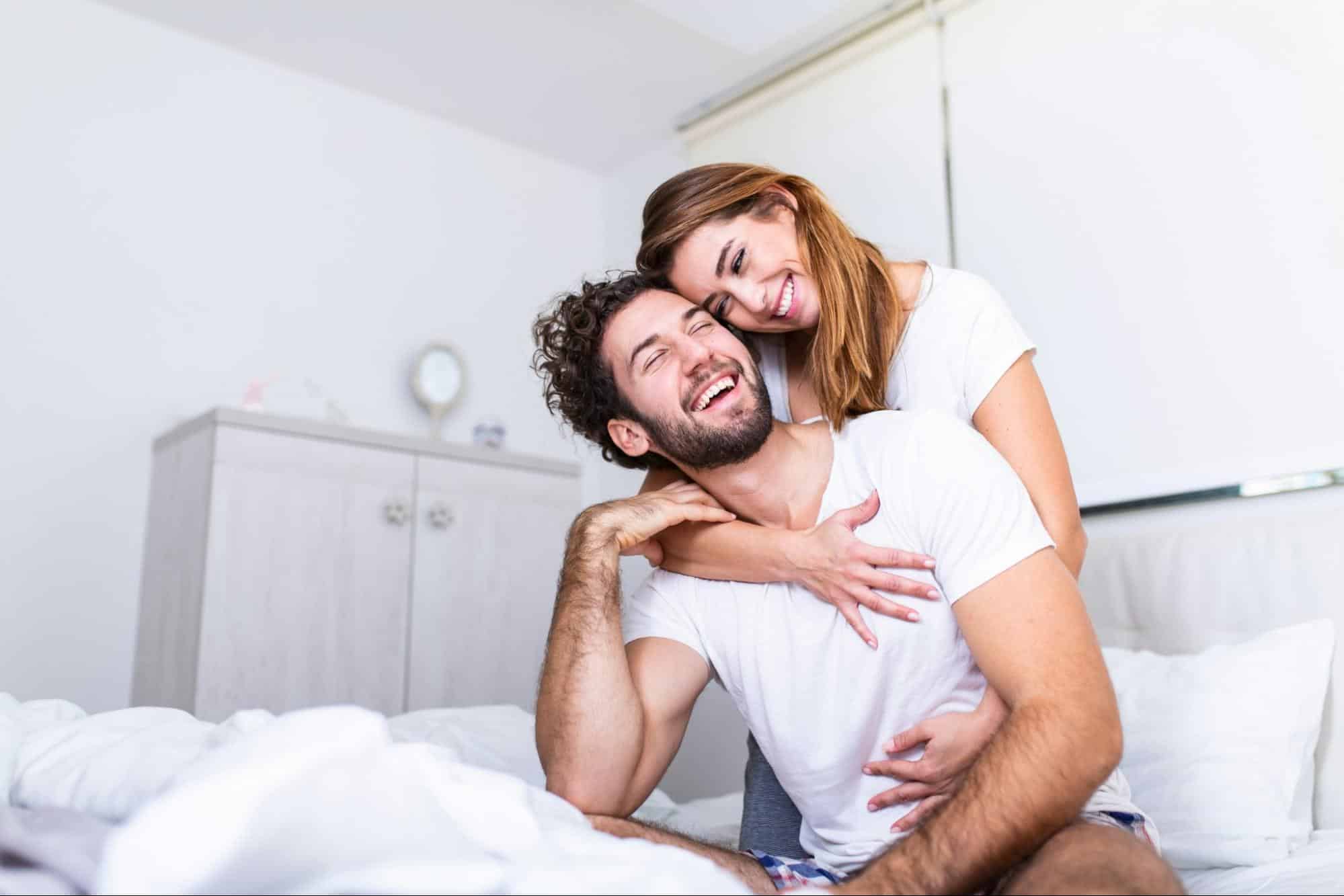 A woman hugging a man