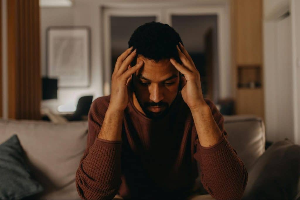A man holding his head