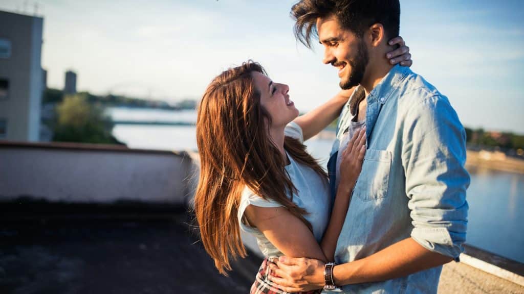 Beautiful young couple in love dating outdoors and smiling.
