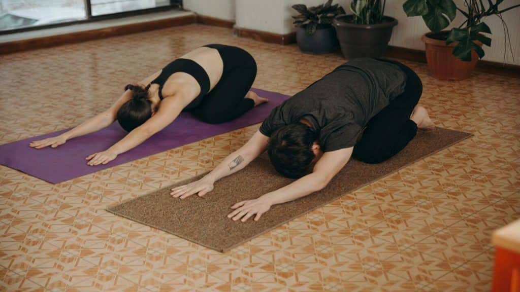 A couple doing yoga together 