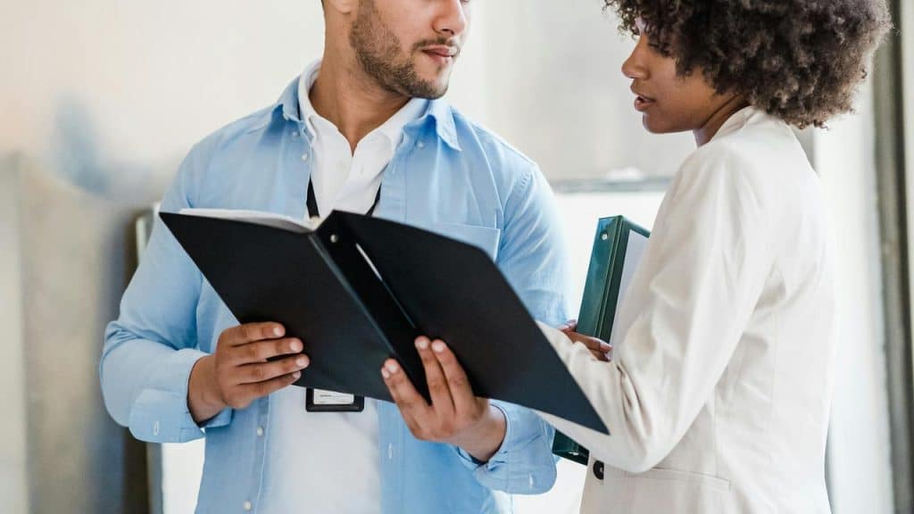 A man and a woman reviewing documents together.