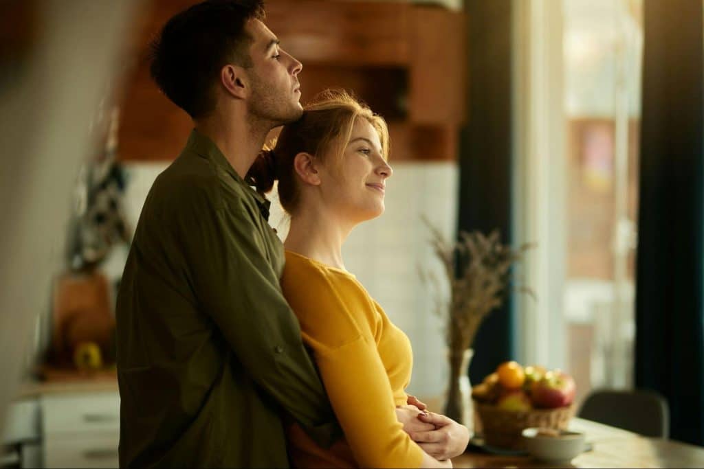 A man hugging a woman 