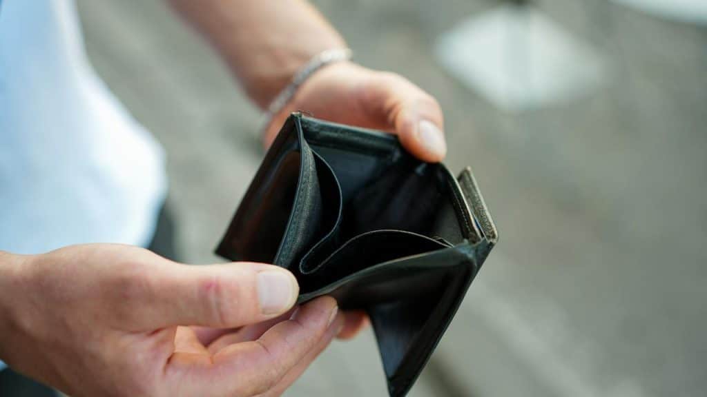An empty wallet held open in two hands.