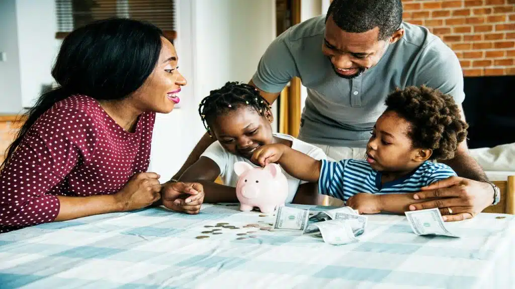 A man teaching his kids how to save