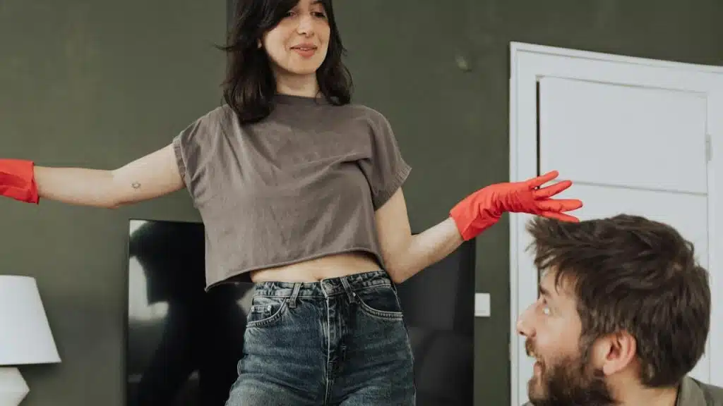 A woman taunting her husband for sitting idle at home.