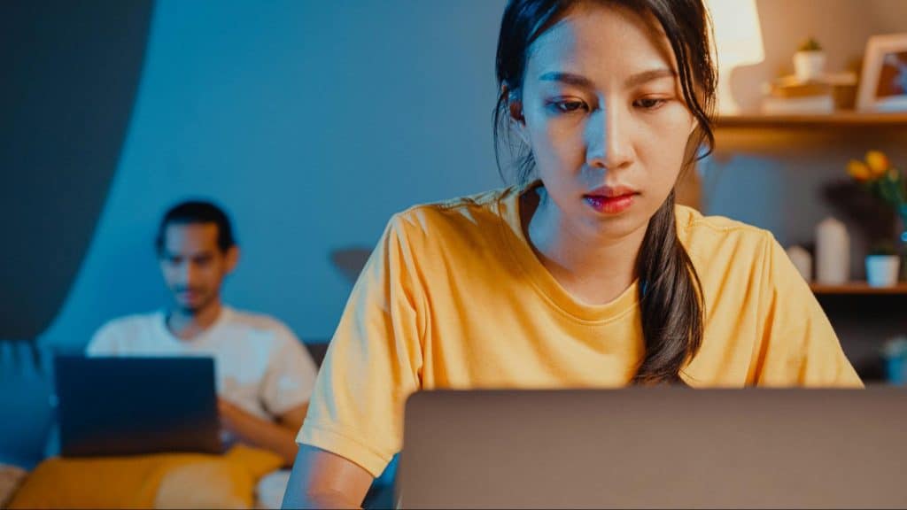 A man and woman busy and not talking