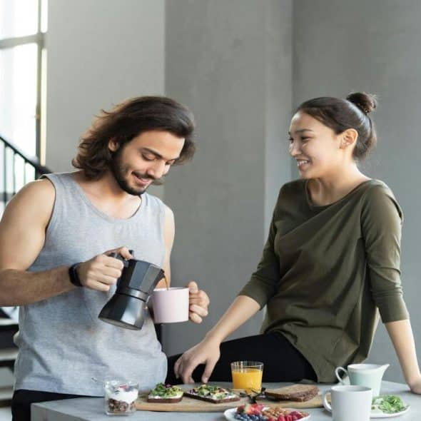 A couple talking while having breakfast
