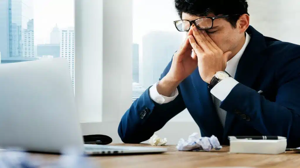 A man looking stressed at work