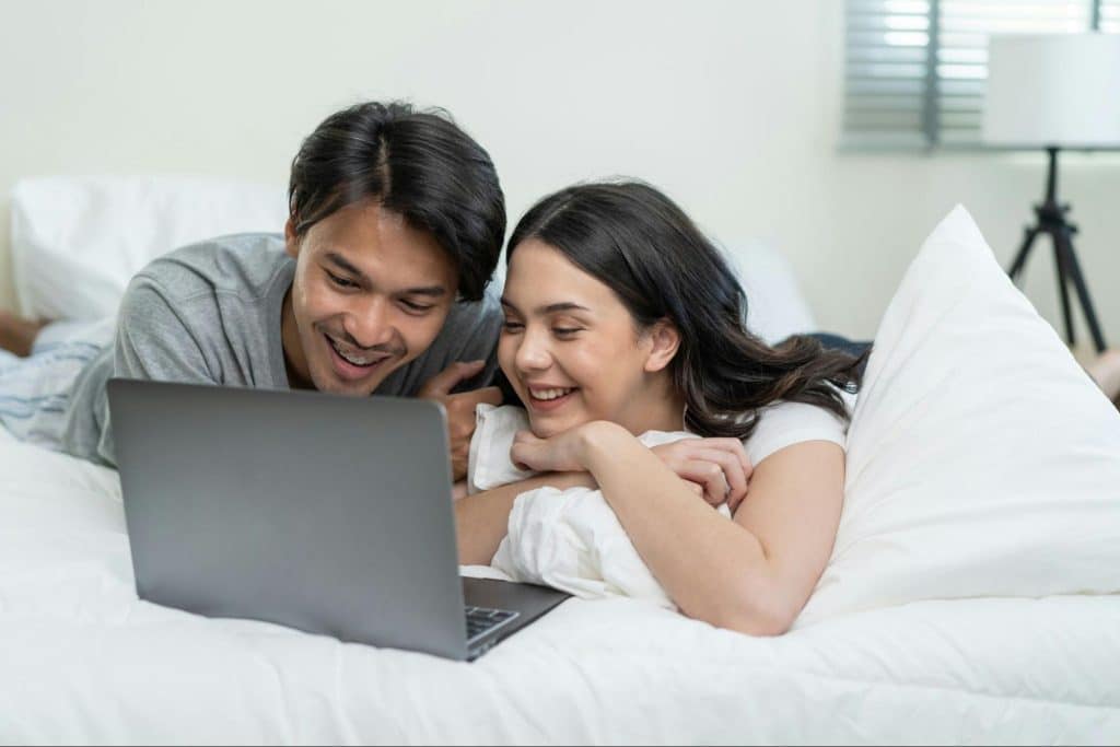 A man and woman at the bed