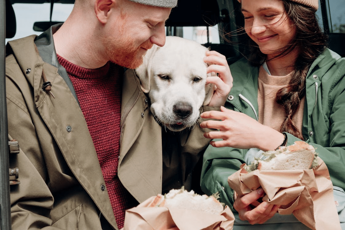 A man and a woman with a dog
