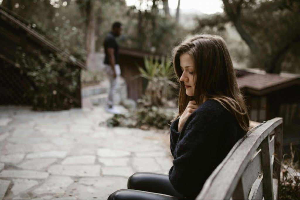 A woman sitting at the bench