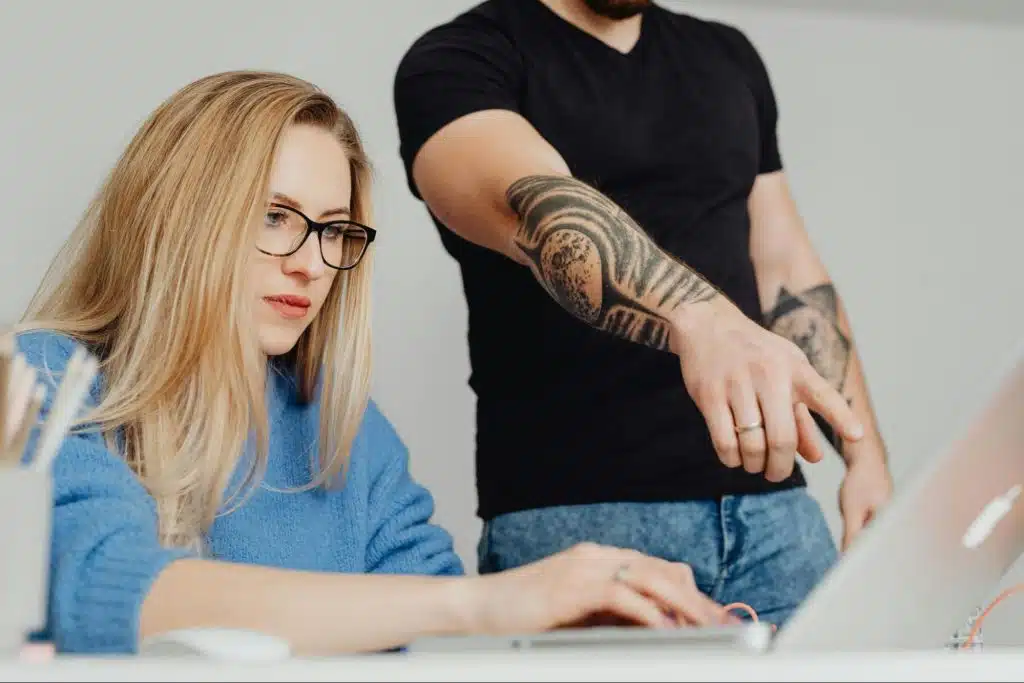 A man dictating something to a woman
