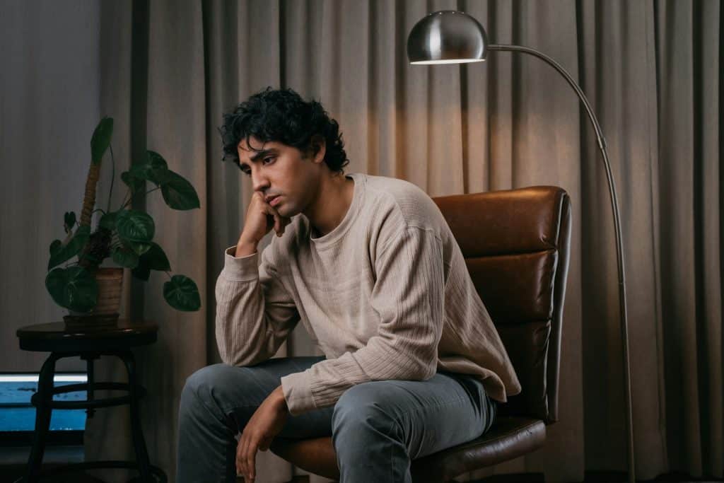 A man sitting in a brown chair.