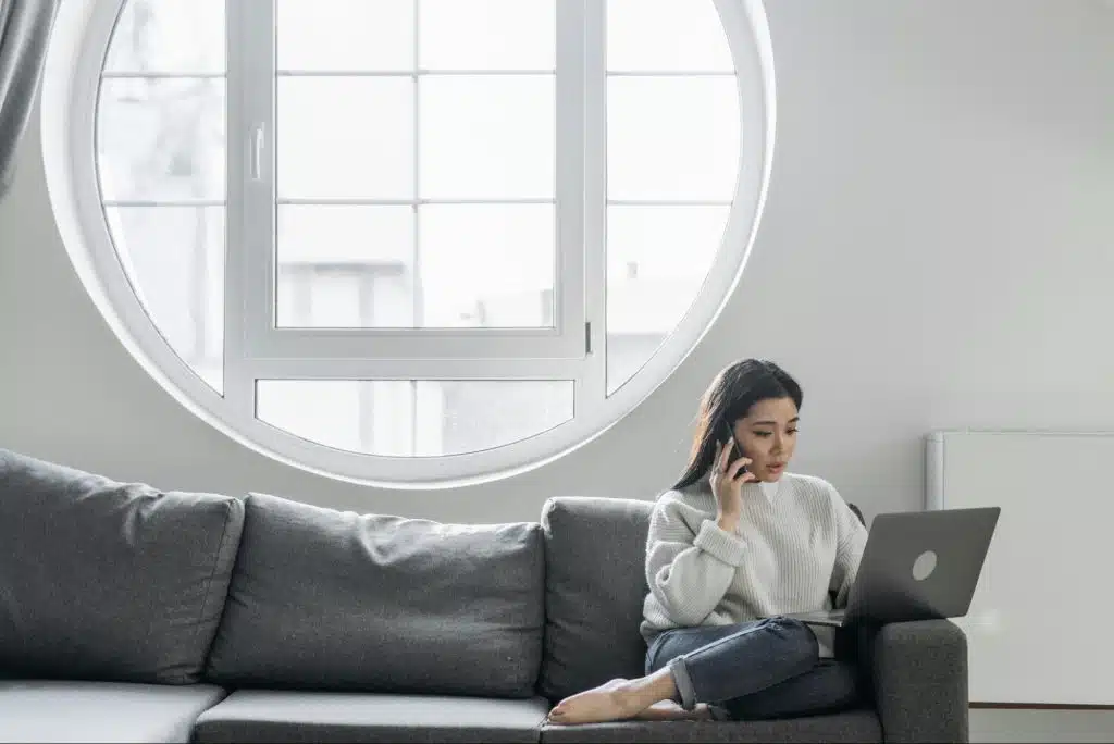 A woman sitting comfortably at the couch