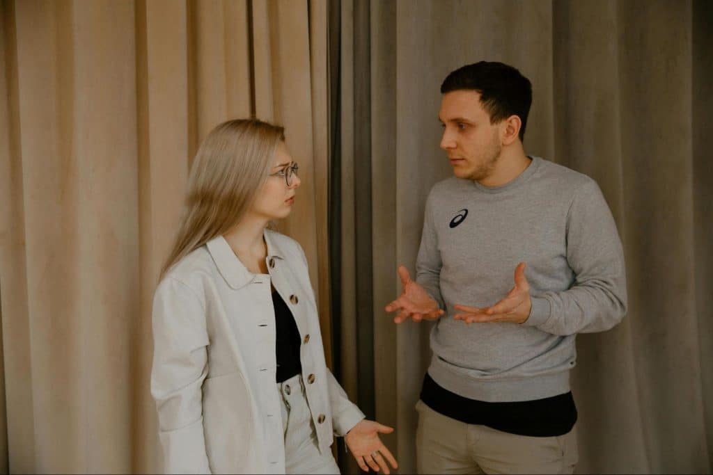 A man questioning a woman