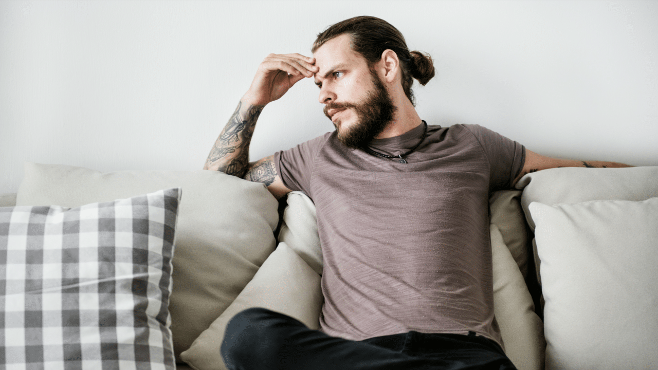 A man looking upset at home