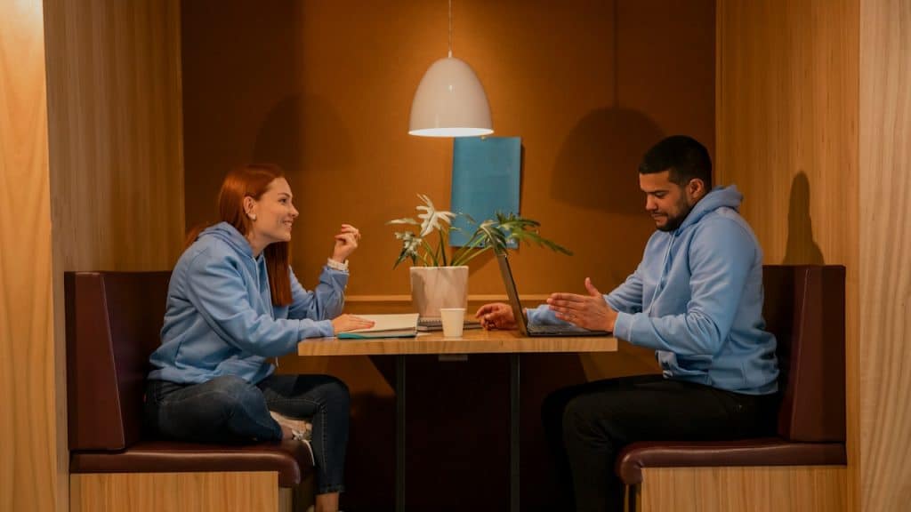A man and a woman sitting at a table.