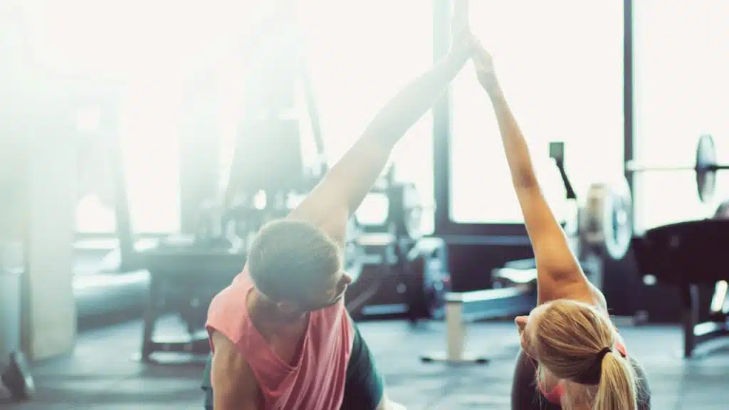 A couple working out together at the gym.