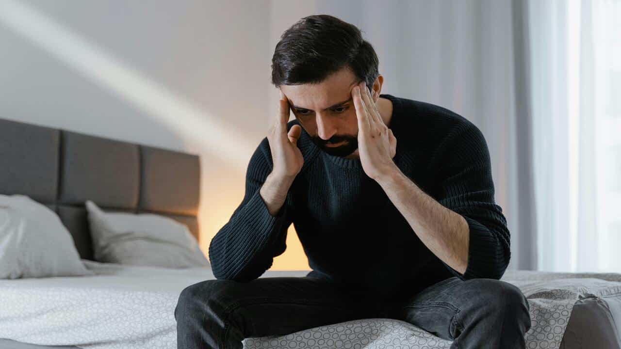 A man looking sad at home