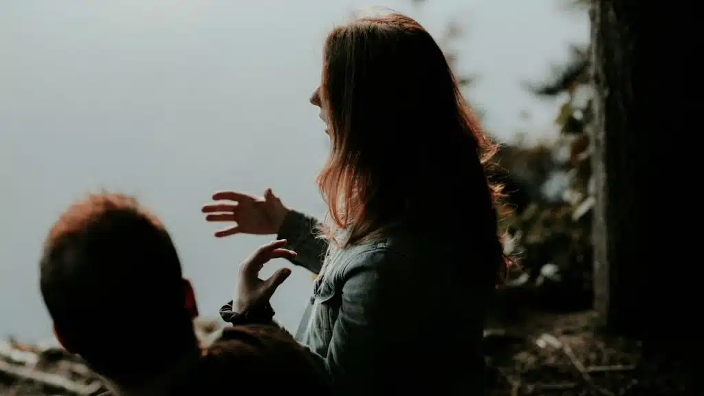Woman wearing a jacket is talking to her boyfriend.