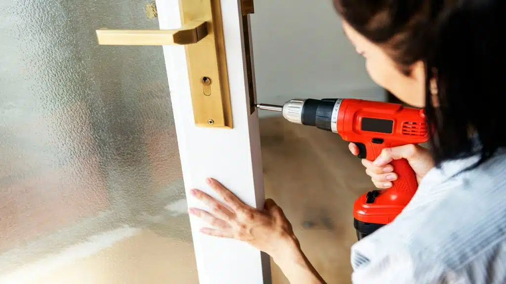 A woman fixing a door