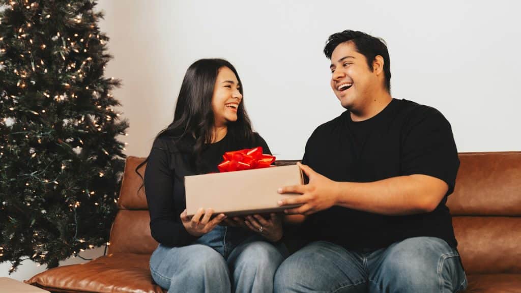 A man giving a gift to the woman.