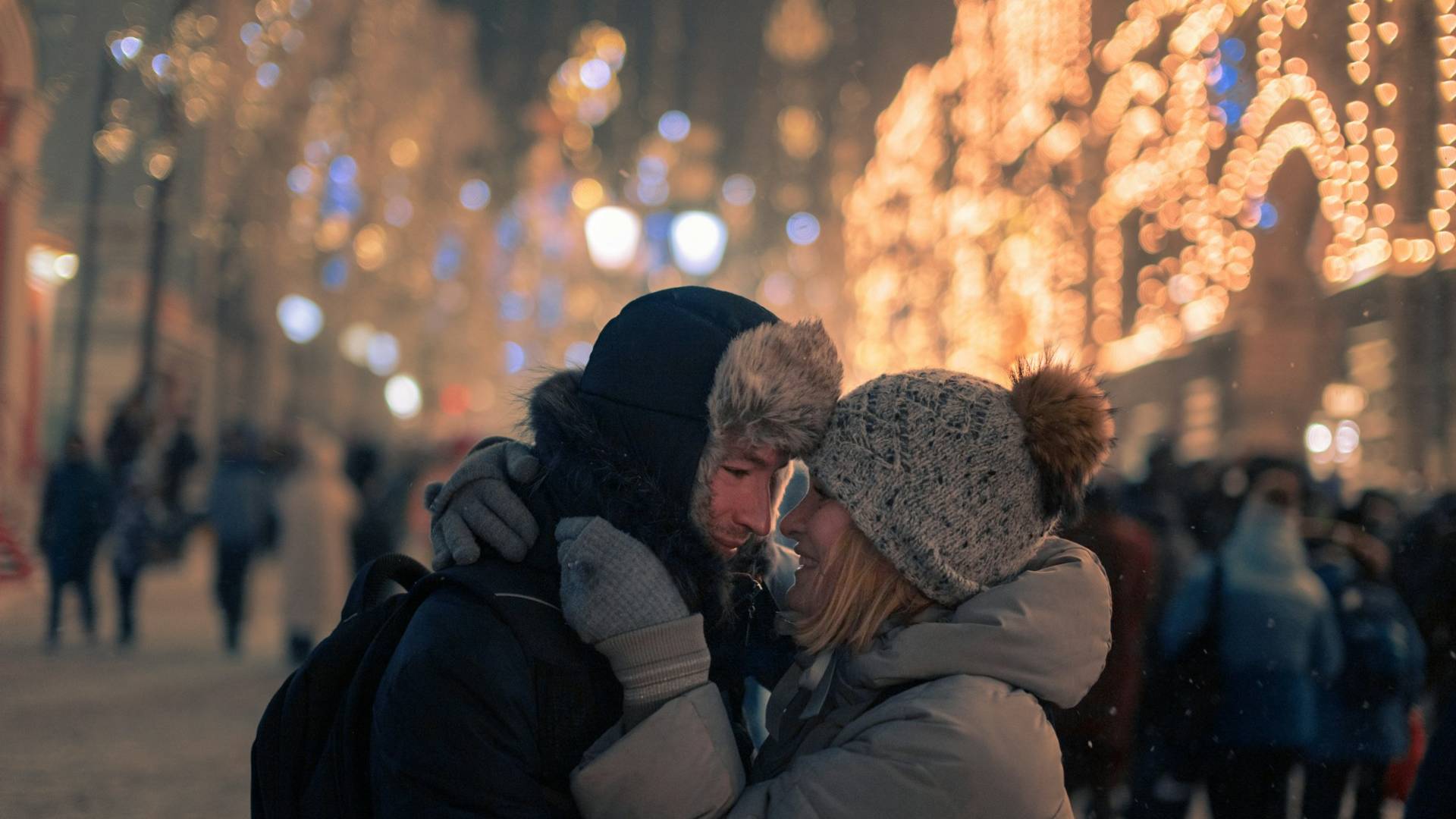 A man and woman hugging in the city.