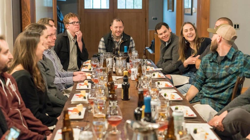 A group of people sitting at a dining table.