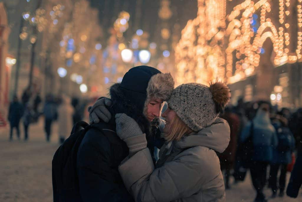 A man and woman hugging in the city.